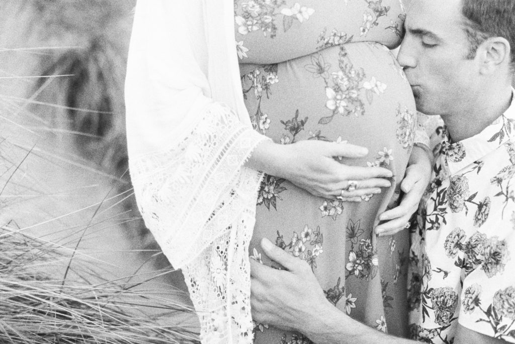 Husband kissing wife pregnant belly