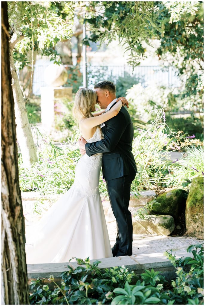 bride and groom embracing in an alcove