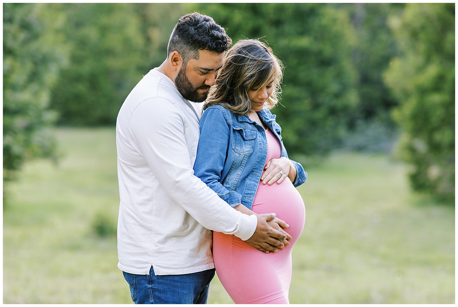 man and woman looking at woman's pregnant belly