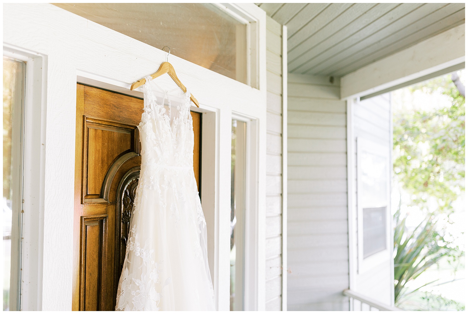 lace wedding dress hanging on a doorframe of house for reedley wedding