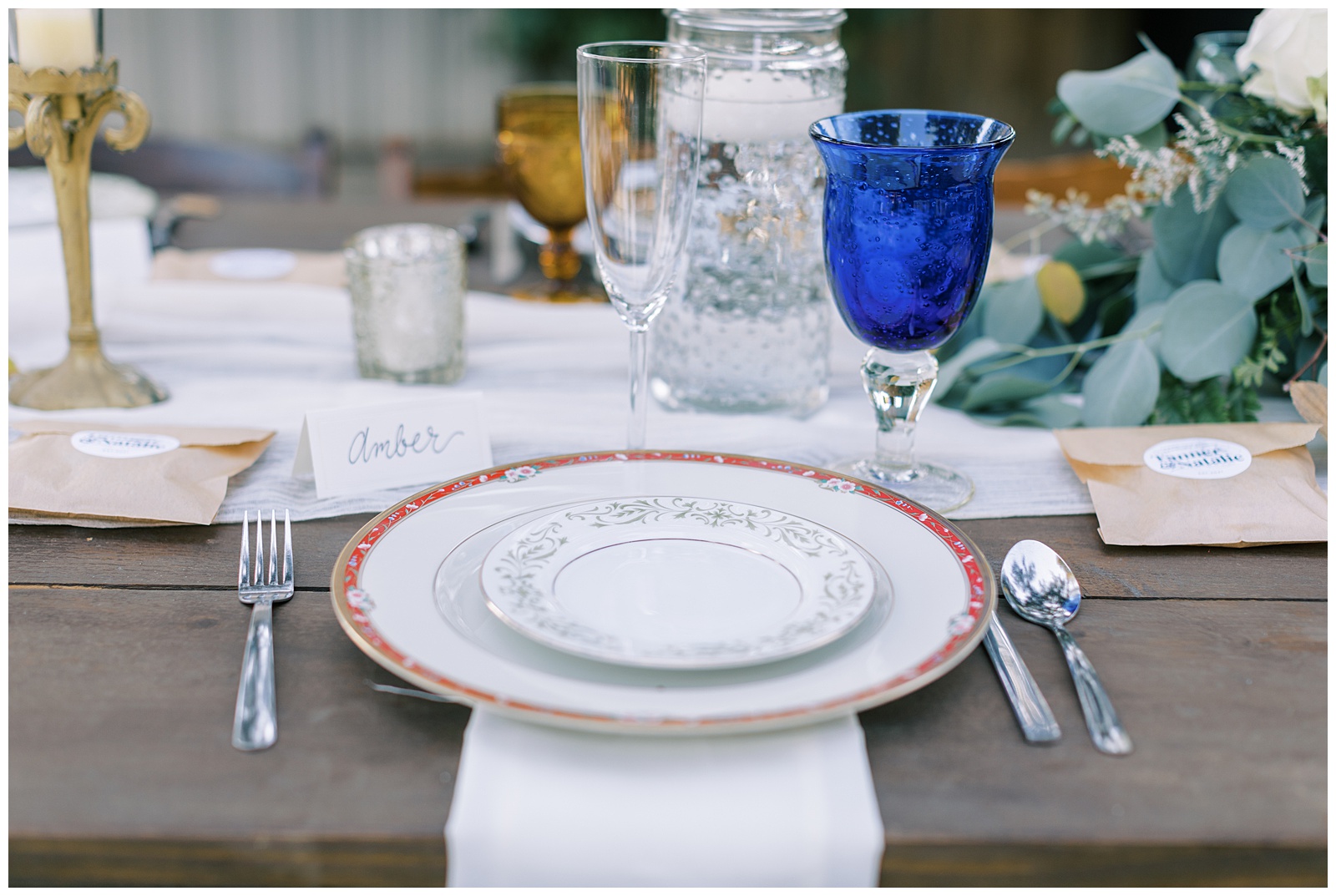 vintage plates on wooden farm style table wedding reception decor
