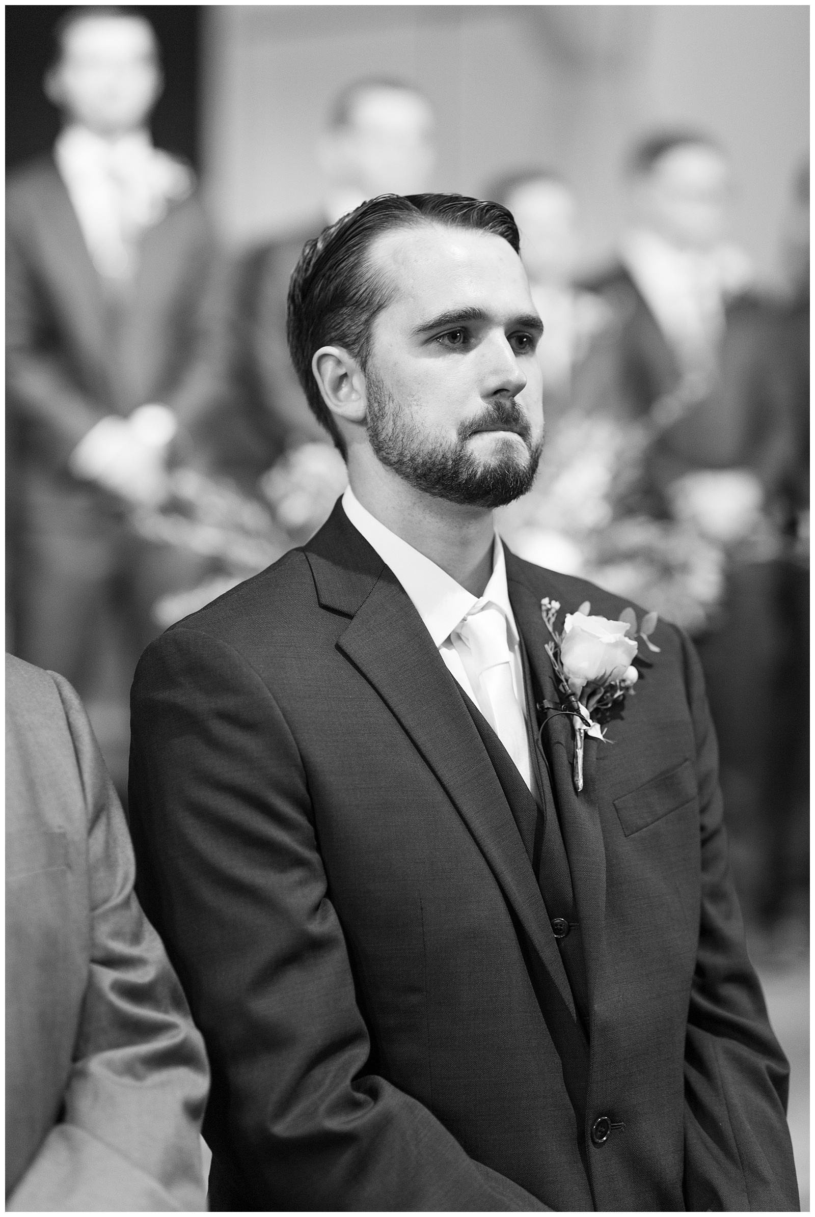 black and white image groom seeing bride walk down aisle