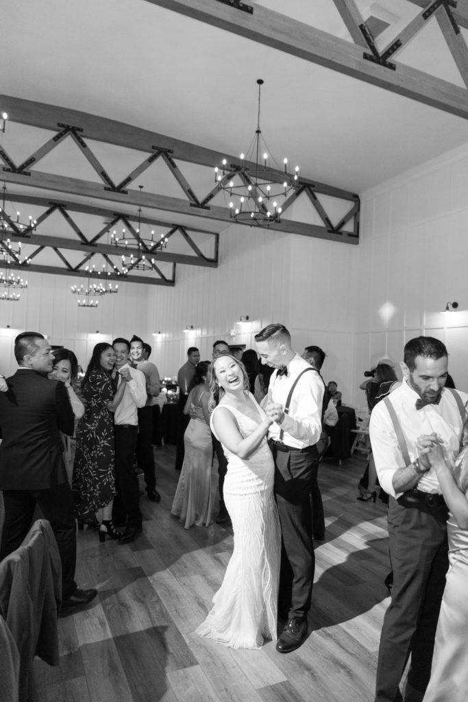 black and white of bride and groom dancing indoors at wedding reception of evanelle vineyards