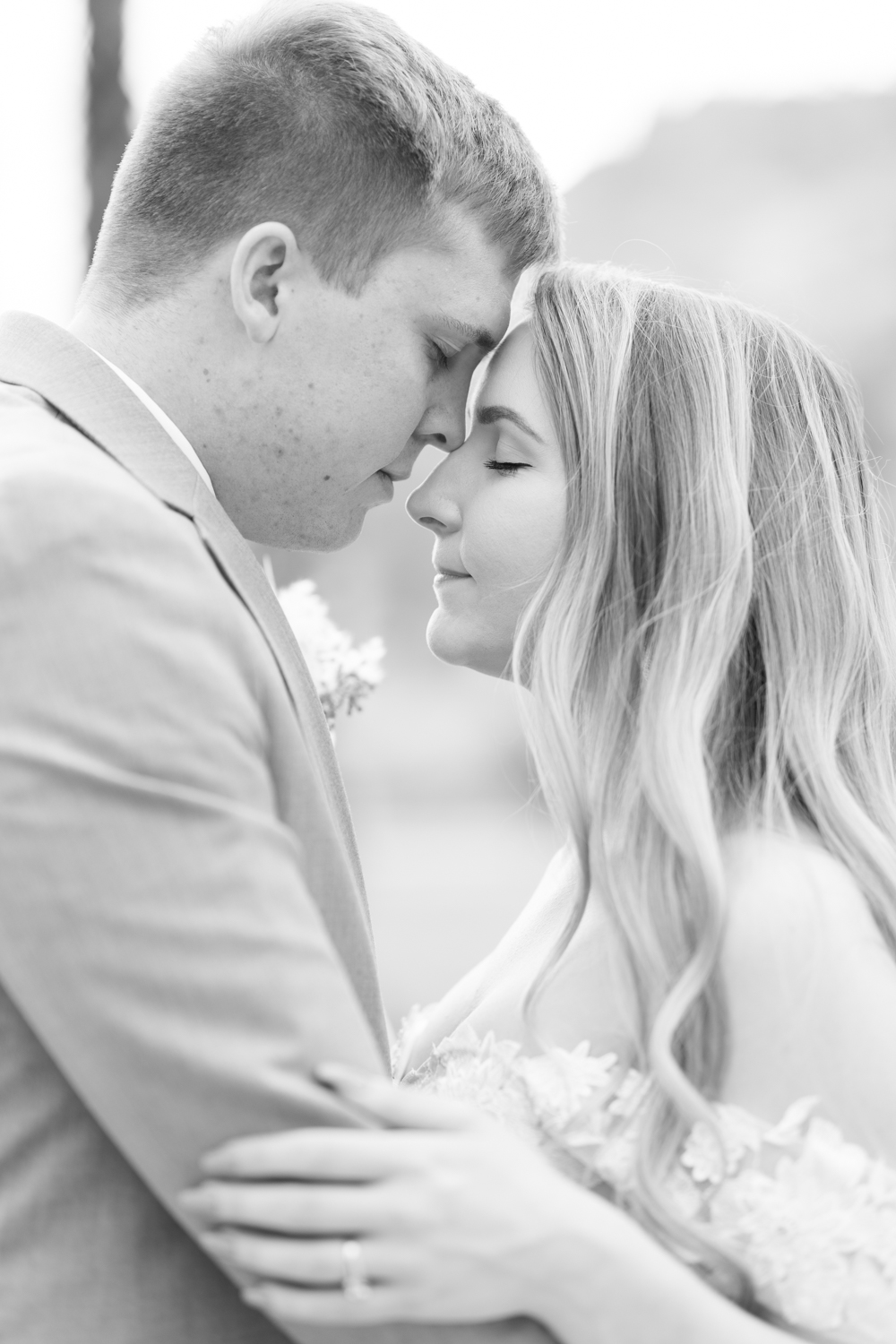 black and white close up bride and groom eyes closed nuzzling noses