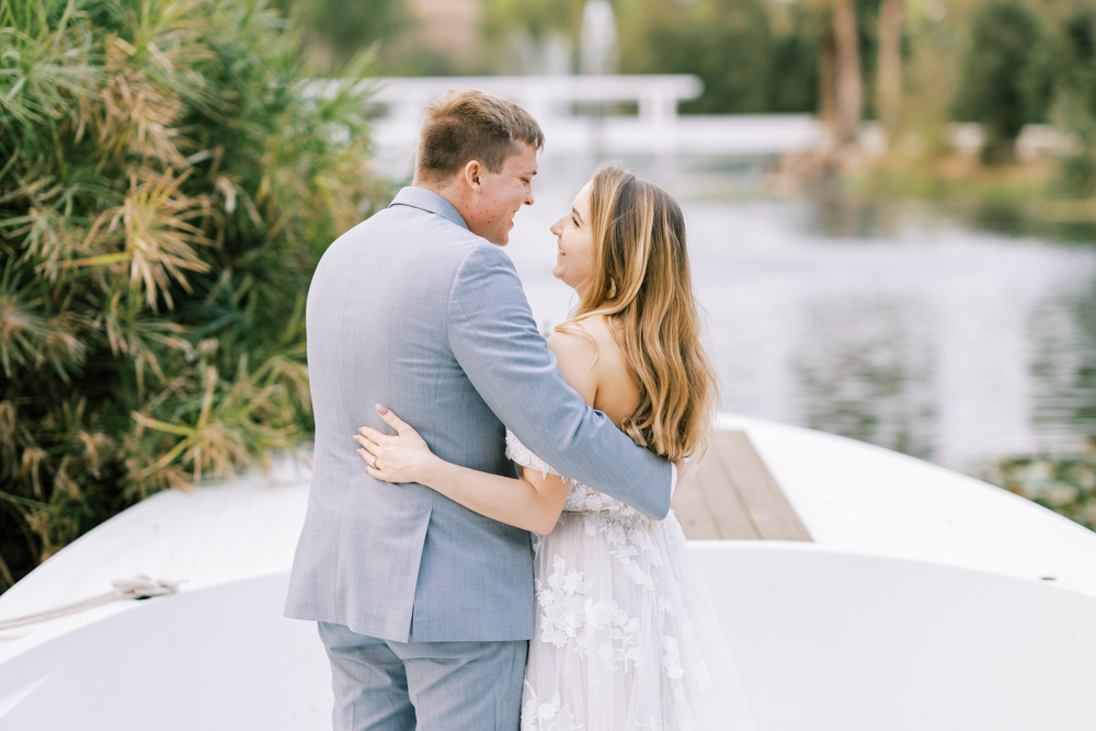 bride and groom embracing on a boat