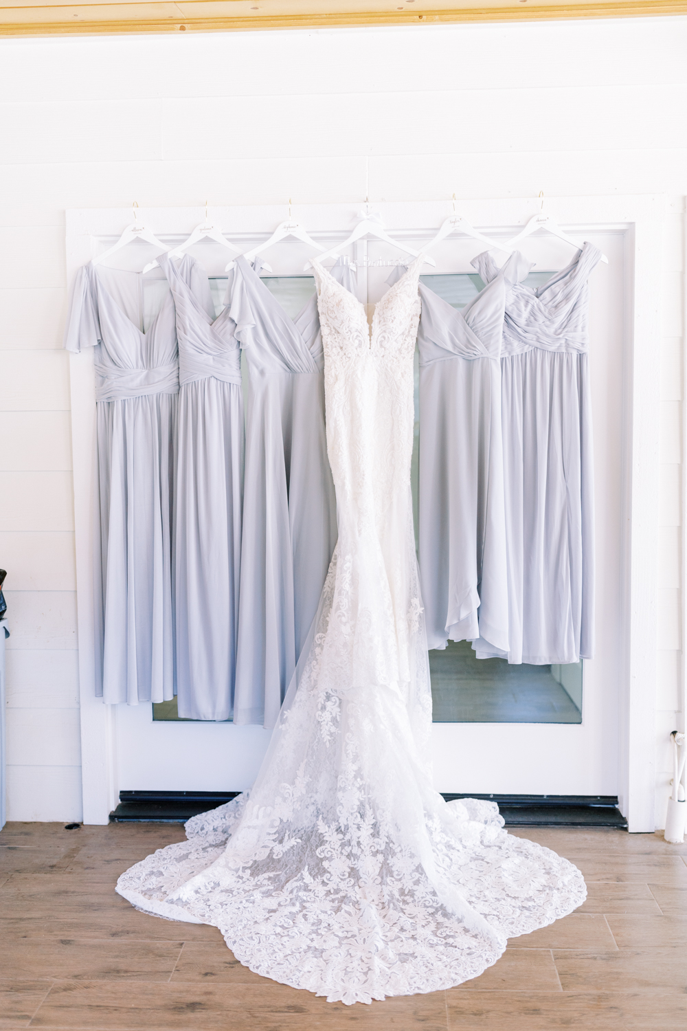 wedding dress hanging with bridesmaid dresses 