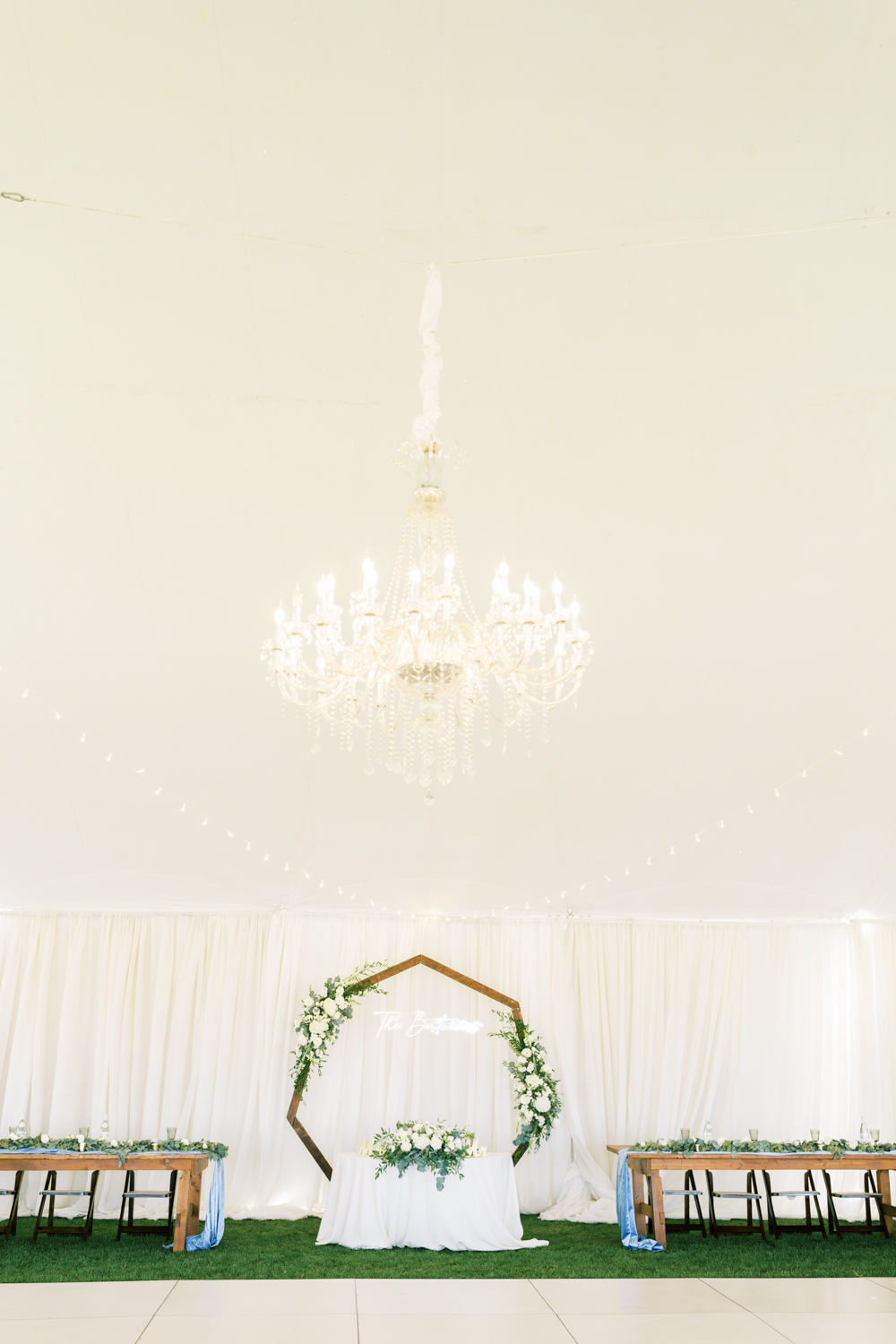 elegant backyard wedding white wedding tent with white and gold decor chandelier neon sign