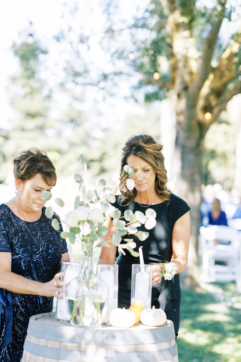 bride and groom's mothers lighting unity candle