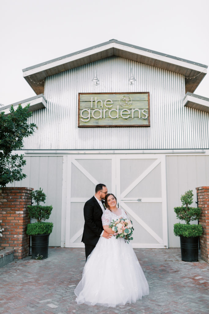 bride and groom in front of the gardens venue in tulare