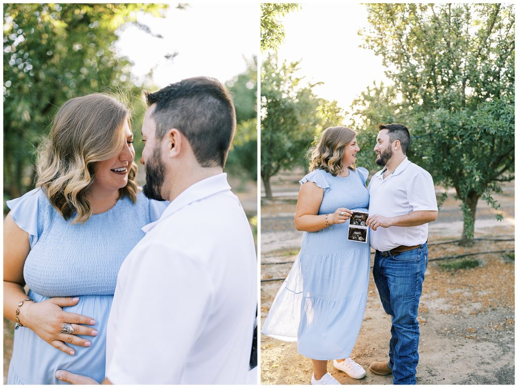 husband and wife embracing and holding sonogram photo