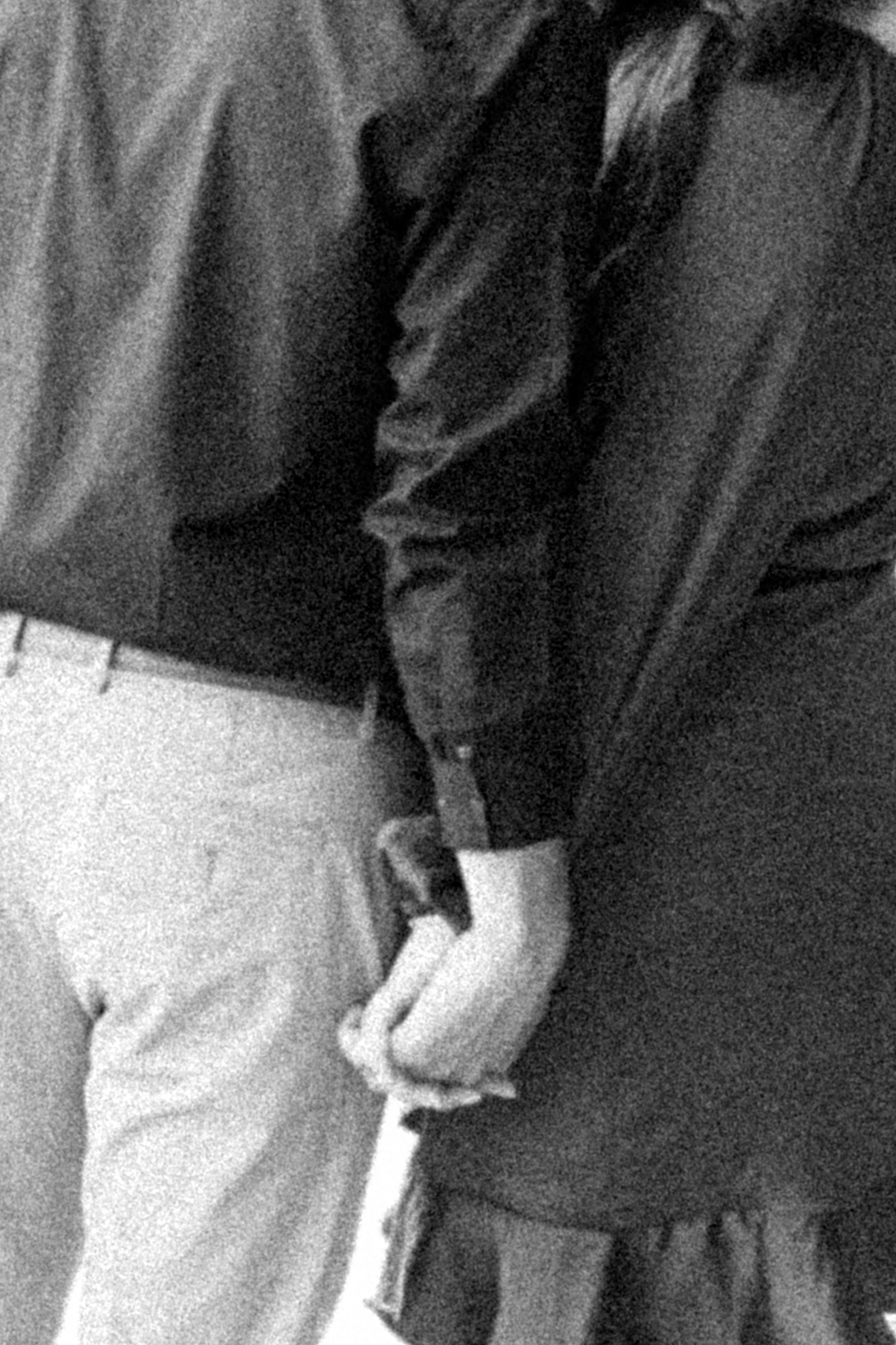 close up black and white grainy film inspired photo of couple holding hands