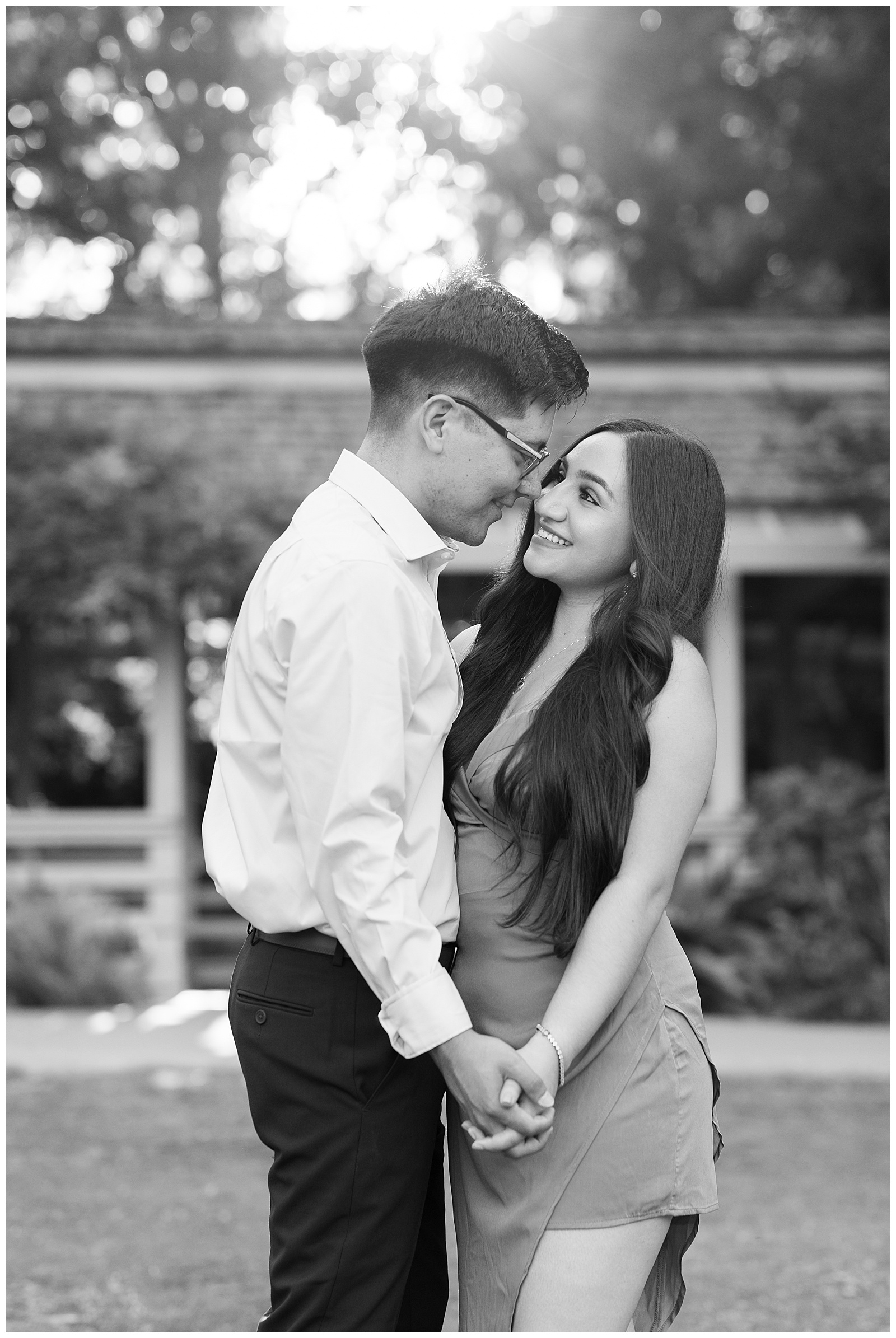 black and white photo engaged couple dancing and holding hands