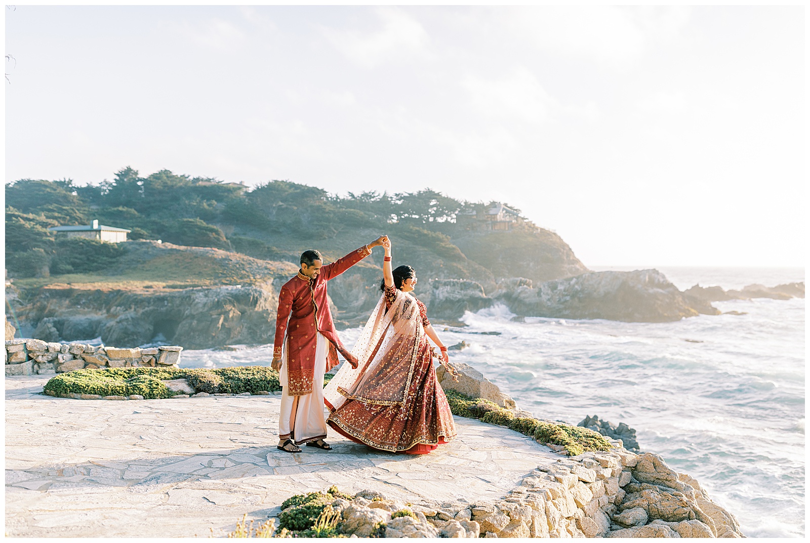 bride and groom in traditional indian wedding attire dancing on cliff by the ocean in carmel-by-the-sea california fresno wedding photographer megan helm photography