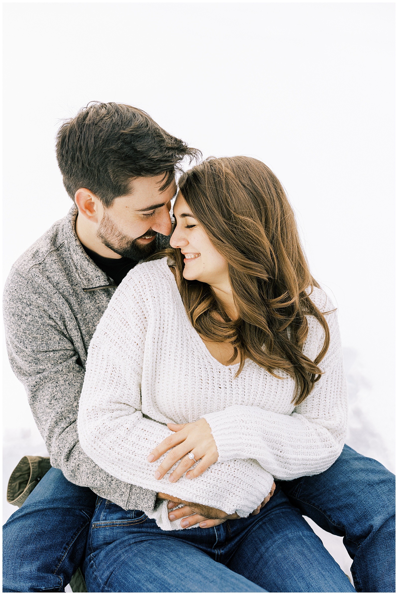couple seated embracing and smiling