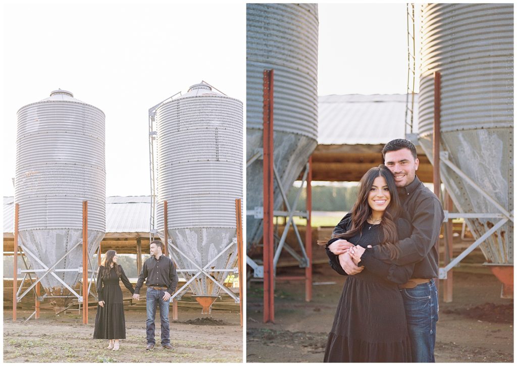 dutton ranch inspired engagement photos of man and woman wearing black and denim embracing and holding hands in front of metal silos western engagement photos