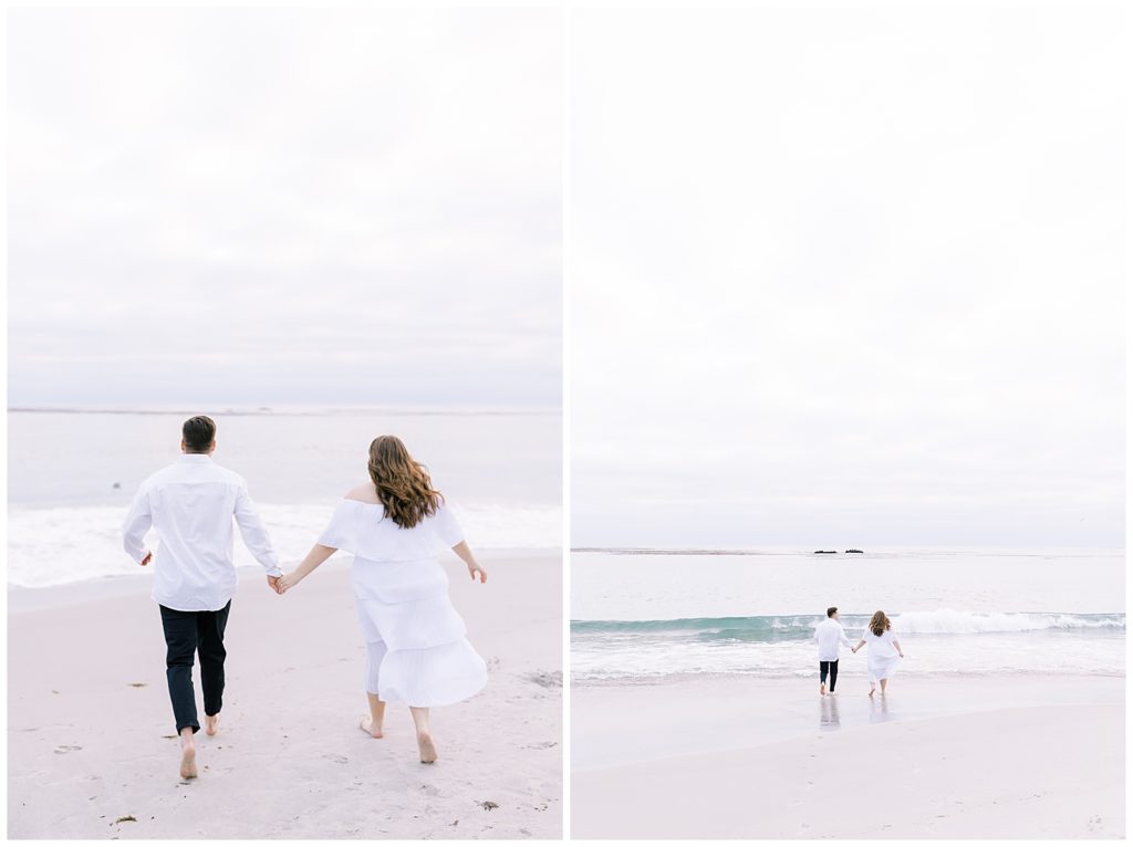couple wearing white holding hands running into pacific ocean after sunset